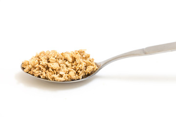 Spoon with granola, on white background.