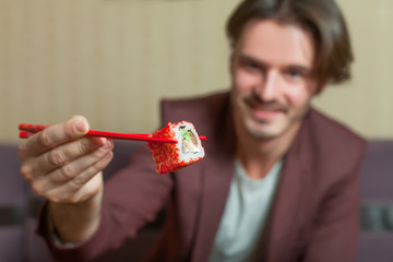 Man hold chopsticks in hand.