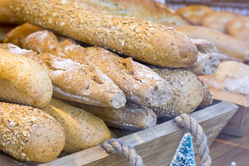 Loaves of integral bread on wooden box.