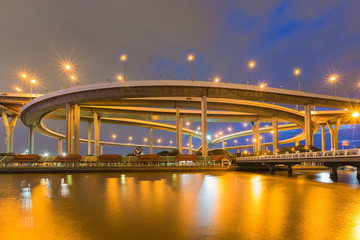 Twilight sky over Highway overpass intersection with reflection lights night view