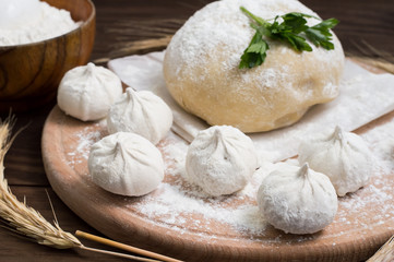 Raw khinkali in the kitchen. The process of preparing hinkaley. Closeup. Top view