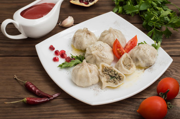 Khinkali cooked, tasty and juicy. Georgian cuisine. Wooden rustic background. Top view