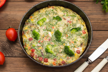 Spanish tortilla in the pan. Wooden rustic table. Top view