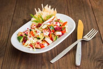 Vegetarian salad with vegetables and cheese crisps. Wooden table. Close-up