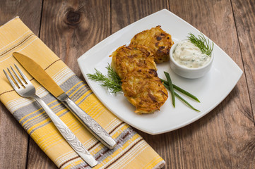 Potato pancakes for breakfast. Wooden rustic background. Top view