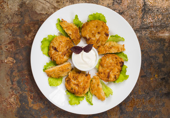 Potato pancakes for breakfast. Old rustic background. Top view. Close-up