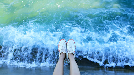  foot of woman relaxing on a bridge.