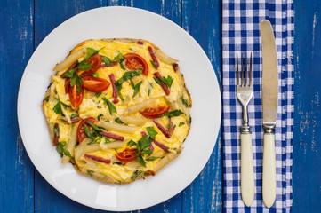 Frittata in Italian on a wooden table. Top view. Close-up