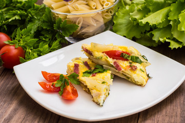 Frittata in Italian on a wooden table. Top view. Close-up