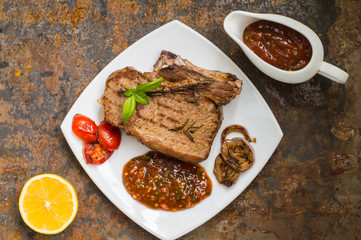 Rare Beef steak medium grilled with barbecue sauce. Old table. Top view