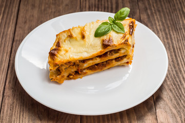 Lasagna, traditional Italian food on a wooden background