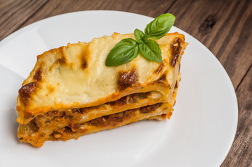 Lasagna, traditional Italian food on a wooden background