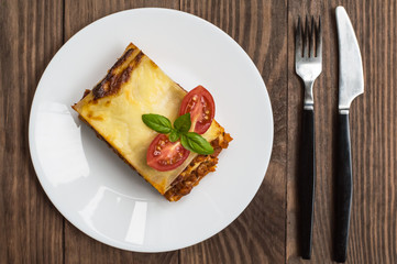 Lasagna, traditional Italian food on a wooden background