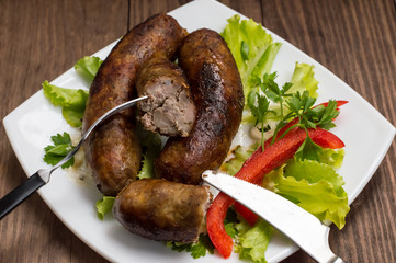 Bavarian sausages cooked on the grill. Wooden table
