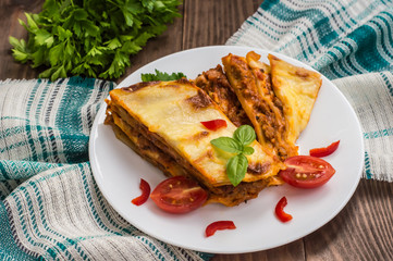 Lasagna, traditional Italian food on a wooden background