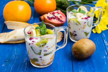 Yogurt with fruit in a glass for breakfast. Old background. Top view. Close-up