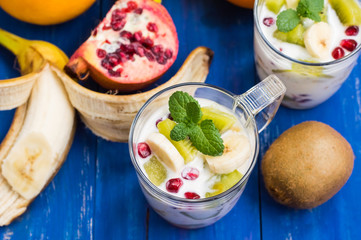 Yogurt with fruit in a glass for breakfast. Old background. Top view. Close-up