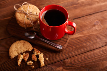 Coffee and Homemade cookies with chocolate. Handmade Chocolate cookies and cup of espresso on wooden table. Pile of delicious chip cookies. Christmas cookies. Biscuits. Oat biscuits.