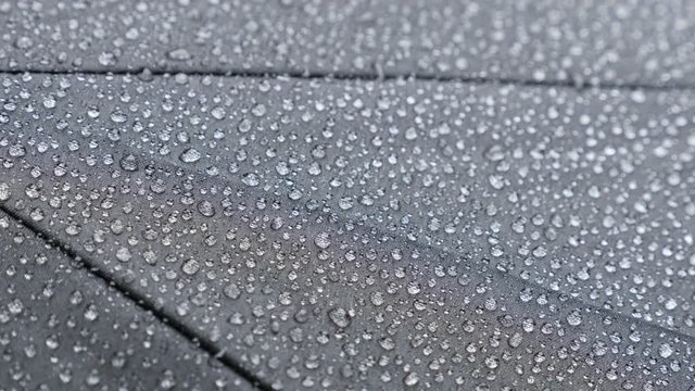 Dark protective umbrella texture and raindrops 4K 2160p 30fps UHD footage - Shallow DOF black waterproof fabric surface 3840X2160 UltraHD video 