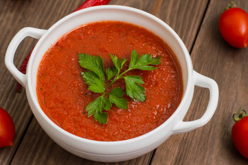 Gazpacho with vegetables. Wooden rustic background. Top view