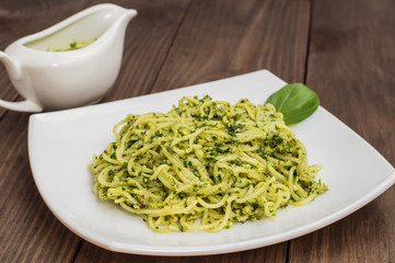 Pasta with pesto Brazilian. Wooden table. Top view