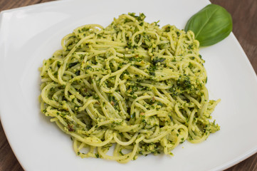Pasta with pesto Brazilian. Wooden table. Top view