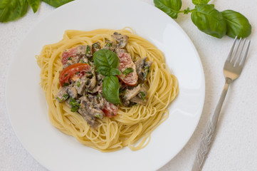 Pappardelle pasta with beef tongue on a white background. Top view