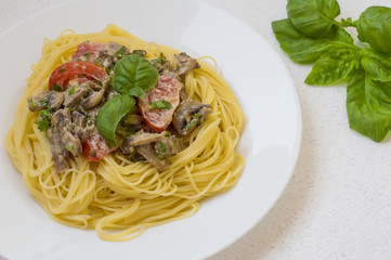 Pappardelle pasta with beef tongue on a white background. Top view