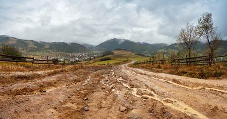 Muddy ground after rain in mountains. Extreme path rural dirt ro