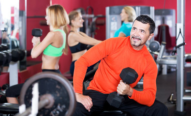 Fototapeta na wymiar Adult people having strength training in gym