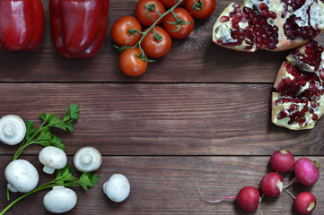 Set of vegetables, herbs and spices for salad. Wooden background. Top view