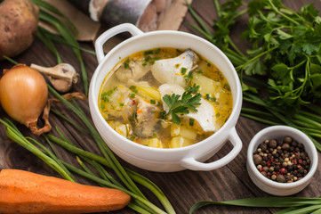 Fresh fish soup with ingredients and spices for cooking. Wooden background. Top view. Close-up
