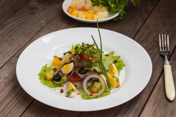 Salad with tongue on the wooden background
