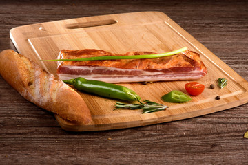 Brisket meat on wooden Board with vegetables