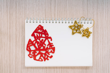 Christmas composition around a blank notebook with space for copy.