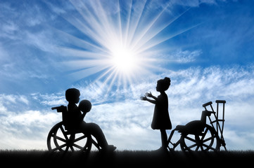 Fototapeta na wymiar Girl playing with boy in wheelchair with ball