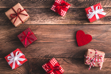 Valentines gifts on wooden background and felt hearts. Flat lay. View from above.