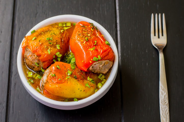Stuffed pepper. Wooden background