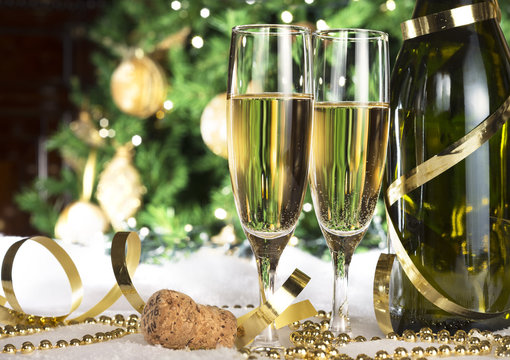 New Year champagne , Christmas tree background, snow