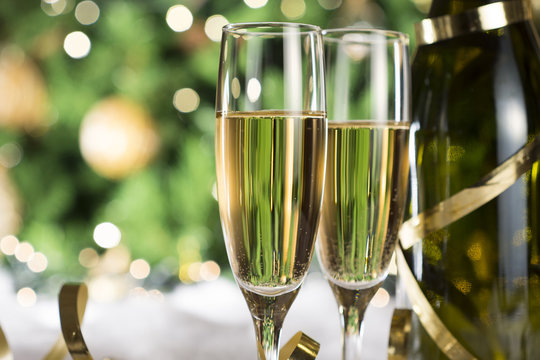 New Year champagne , Christmas tree background, snow