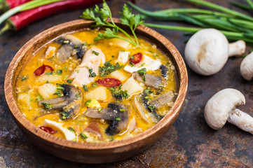 Delicious soup with smoked chicken, mushrooms,  eggs and cream. Old background. Top view