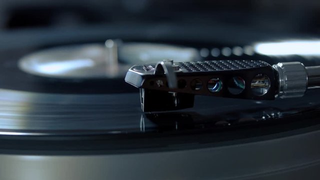 Turntable stylus going down. record playing on a vinyl record player. close-up