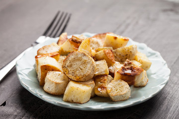 Roasted sweet potatoes and parsnips organic angled view on a wooden background