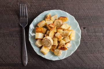 Roasted sweet potatoes and parsnips organic on a wooden background top view