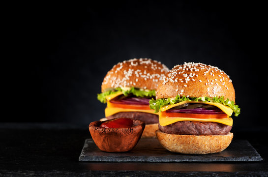 Beef burgers cheeseburgers on a black chalkboard