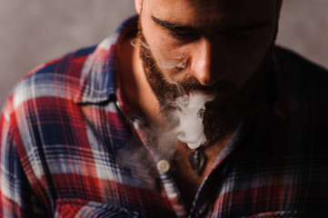 Brutal man smoking electronic cigarette