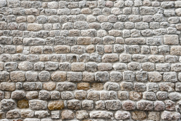 Close up view of a textured stone wall of a historical building
