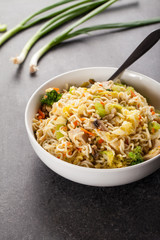 Chinese chicken lo mein with cabbage, carrots, celery, mushrooms, turnips, broccoli, and assorted vegetables side view