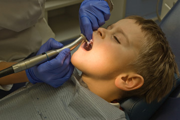 Five y.o. boy is under procedure of cleaning his teeth by the dentist - 130838372