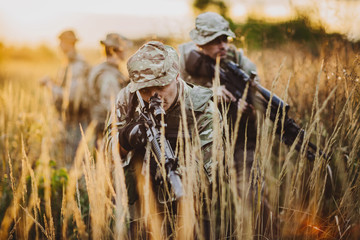 Rangers shooting with his weapon, rifle at sunset. War, army